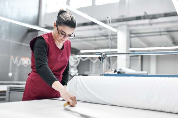 纺织厂女工正在测量尺寸