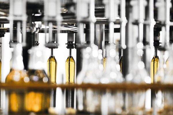 Bottles being filled on an automated beverage production line
